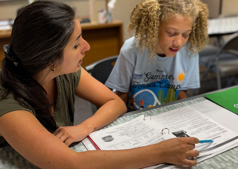 Summer tutor studying with student